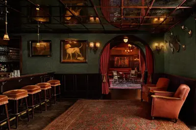 a pub with a bar with a dog on the wall at The Bowery Hotel in New York