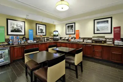 a restaurant with two tables and chairs and a counter at Hampton Inn Philadelphia-Great Valley in Frazer