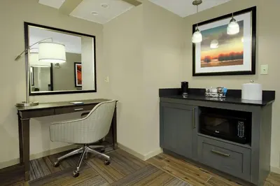 a room with a desk and a chair and a mirror at Hampton Inn Philadelphia-Great Valley in Frazer