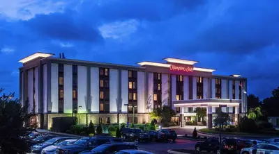 a hotel with cars parked in a parking lot at Hampton Inn Philadelphia-Great Valley in Frazer