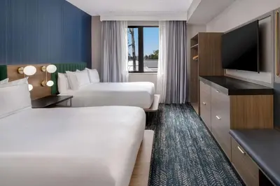 a hotel room with two beds and a flat screen tv at DoubleTree Suites by Hilton Mount Laurel in Mount Laurel