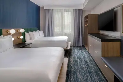 a hotel room with two beds and a flat screen tv at DoubleTree Suites by Hilton Mount Laurel in Mount Laurel