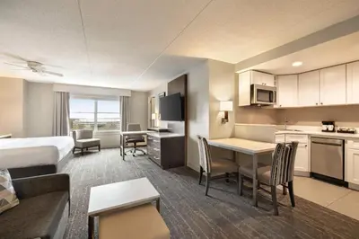a hotel room with a king bed and a kitchen at Homewood Suites by Hilton Philadelphia-City Avenue in Philadelphia