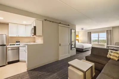 a kitchen and living room with a couch and a room with a bed at Homewood Suites by Hilton Philadelphia-City Avenue in Philadelphia