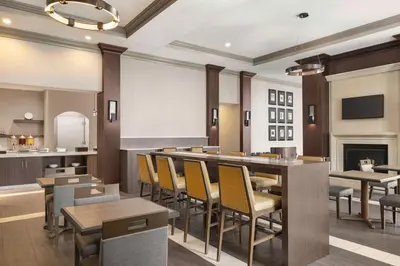 a restaurant with tables and chairs and a fireplace at Homewood Suites by Hilton Philadelphia-City Avenue in Philadelphia