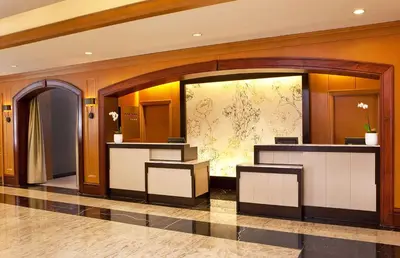 a lobby with a reception desk in a building at Hilton Short Hills in Short Hills