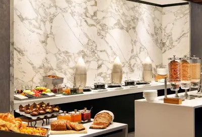 a buffet line with different types of bread and pastries at Hilton Short Hills in Short Hills