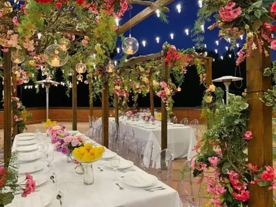 a banquet hall with white tables and flowers at Hilton Short Hills in Short Hills