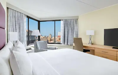 a hotel room with a bed and a desk with a television at DoubleTree by Hilton Hotel Philadelphia Center City in Philadelphia