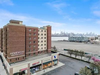 a view of a city with a river and buildings at Homewood Suites by Hilton Edgewater-NYC Area in Edgewater