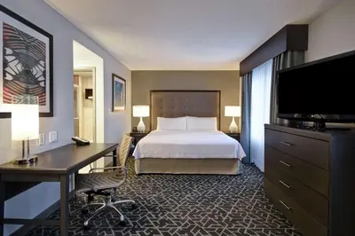 a hotel room with a bed and a desk and a television at Homewood Suites by Hilton Edgewater-NYC Area in Edgewater