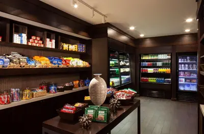 a grocery store aisle with a counter with food at Embassy Suites by Hilton Philadelphia Airport in Philadelphia