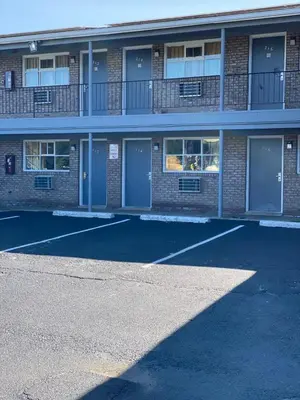 an empty parking lot in front of a building at Bel Air Motor Lodge in Maple Shade