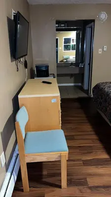 a room with a desk and a chair and a television at Bel Air Motor Lodge in Maple Shade