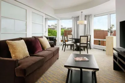 a living room with a couch and a table at The Inn at Penn, A Hilton Hotel in Philadelphia
