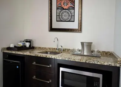 a kitchen with a sink and a microwave at The Inn at Penn, A Hilton Hotel in Philadelphia