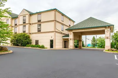 a large building with a parking lot in front of it at Quality Inn Hackettstown - Long Valley in Hackettstown