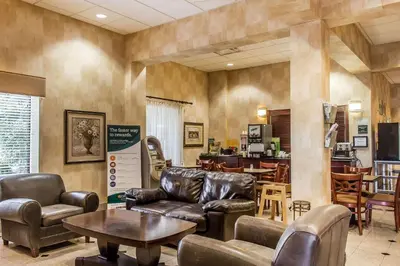 a waiting room with leather furniture and a table at Quality Inn Hackettstown - Long Valley in Hackettstown