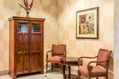 a room with two chairs and a table and a cabinet at Quality Inn Hackettstown - Long Valley in Hackettstown