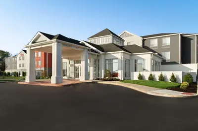 a large house with a driveway in front of it at Hilton Garden Inn Kennett Square in Kennett Square