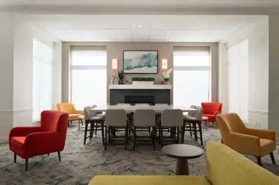 a dining room with a table and chairs at Hilton Garden Inn Kennett Square in Kennett Square