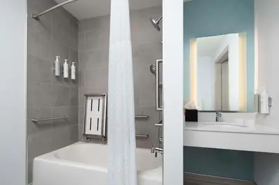 a bathroom with a bath tub and a sink at Hilton Garden Inn Kennett Square in Kennett Square