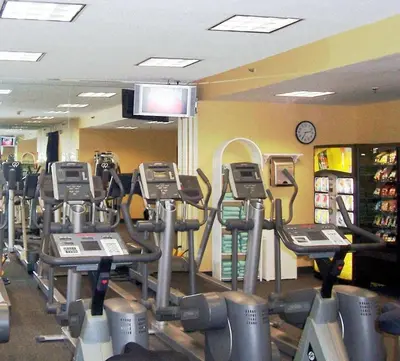 a gym with rows of cardio equipment and a clock at DoubleTree by Hilton Hotel & Executive Meeting Center Somerset in Somerset