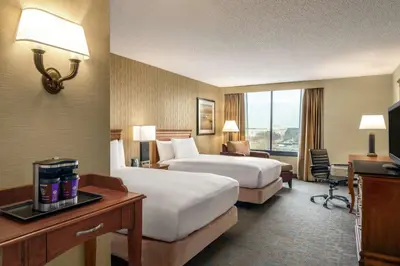 a hotel room with two beds and a desk at DoubleTree by Hilton Hotel & Executive Meeting Center Somerset in Somerset