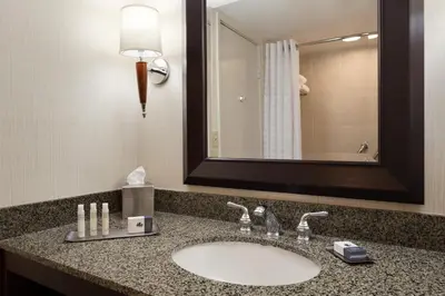 a bathroom with a sink and a mirror at DoubleTree by Hilton Hotel & Executive Meeting Center Somerset in Somerset