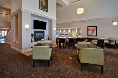 a restaurant with tables and chairs and a dining room at Homewood Suites by Hilton Philadelphia-Great Valley in Malvern