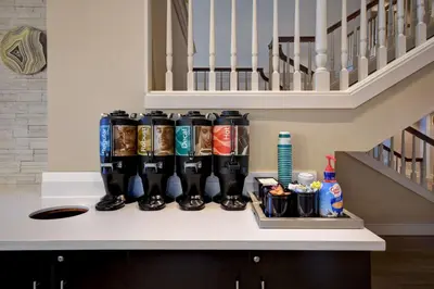 a counter with a row of soda cans on it at Homewood Suites by Hilton Philadelphia-Great Valley in Malvern