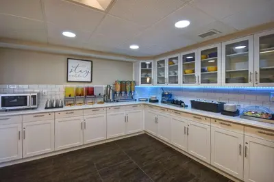 a large kitchen with white cabinets and a microwave at Homewood Suites by Hilton Philadelphia-Great Valley in Malvern