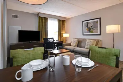 a living room with a table and a couch at Homewood Suites by Hilton Philadelphia-Great Valley in Malvern