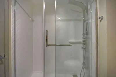 a shower with a glass door in a bathroom at Homewood Suites by Hilton Philadelphia-Great Valley in Malvern