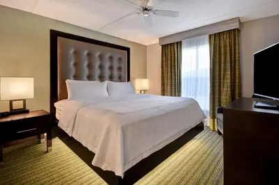a hotel room with a bed and a large window at Homewood Suites by Hilton Philadelphia-Great Valley in Malvern