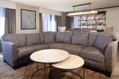 a living room with a couch and two tables at Hilton Parsippany in Parsippany