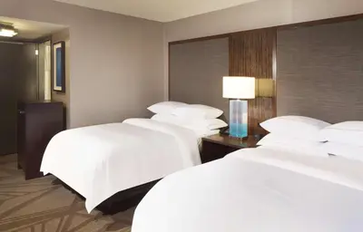 a row of beds in a hotel room at Hilton Parsippany in Parsippany