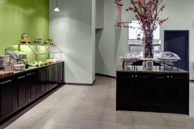 a kitchen with a counter with a vase of flowers at Hilton Garden Inn New York/Manhattan-Chelsea in New York