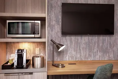 a living room with a microwave and a tv at Hilton Garden Inn New York/Manhattan-Chelsea in New York
