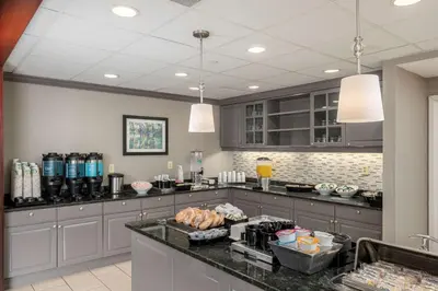 a kitchen with a counter with food on it at Homewood Suites by Hilton Mount Laurel in Mount Laurel