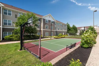 a tennis court with a basketball hoop at Homewood Suites by Hilton Mount Laurel in Mount Laurel