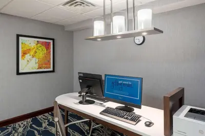 an office cubicle with a computer on a desk at Homewood Suites by Hilton Mount Laurel in Mount Laurel