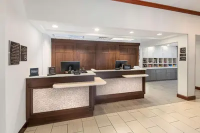 a lobby with two desks with computers on them at Homewood Suites by Hilton Mount Laurel in Mount Laurel
