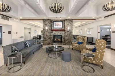 a living room with a couch and a fireplace at Homewood Suites by Hilton Mount Laurel in Mount Laurel
