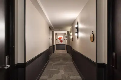a corridor in a hotel with a corridoraceuticalaceuticalaceuticalaceuticalaceuticalaceuticalaceutical companies at Kimpton Theta New York - Times Square by IHG in New York
