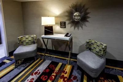 a waiting room with two chairs and a table at Hampton Inn & Suites Staten Island in Staten Island