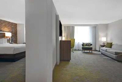 a hotel room with a bed and a couch at Hilton Hasbrouck Heights-Meadowlands in Hasbrouck Heights