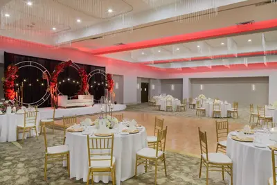 a banquet hall with white tables and chairs at Hilton Hasbrouck Heights-Meadowlands in Hasbrouck Heights