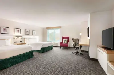 a hotel room with two beds and a flat screen tv at Hilton Garden Inn Bridgewater in Bridgewater