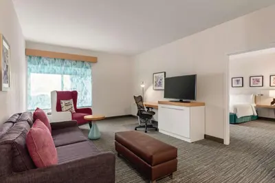 a hotel room with a couch and a tv and a bed at Hilton Garden Inn Bridgewater in Bridgewater